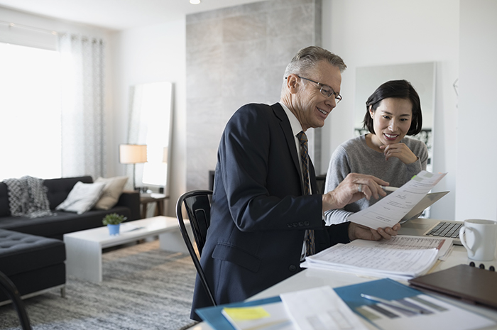 Financial advisor presents customer plans in house.