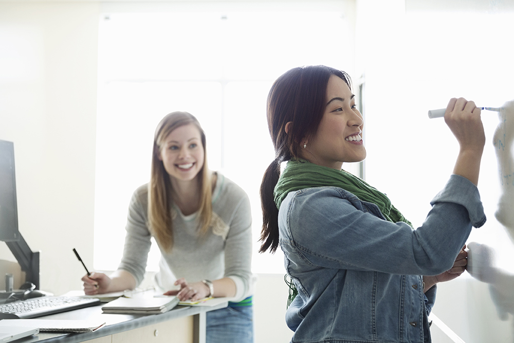 Female students working in classroom at college campus