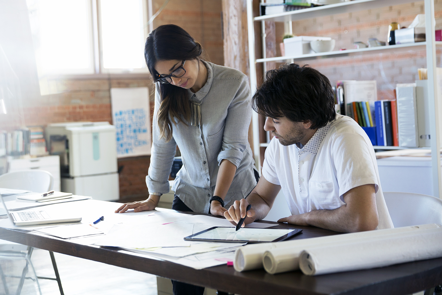 Designers reviewing and discussing plans in office