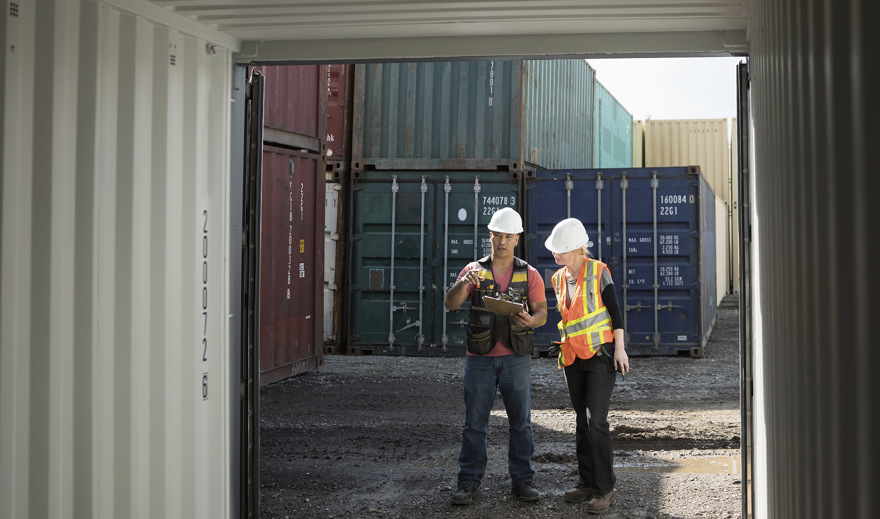 工人在工业集装箱场检查空货柜