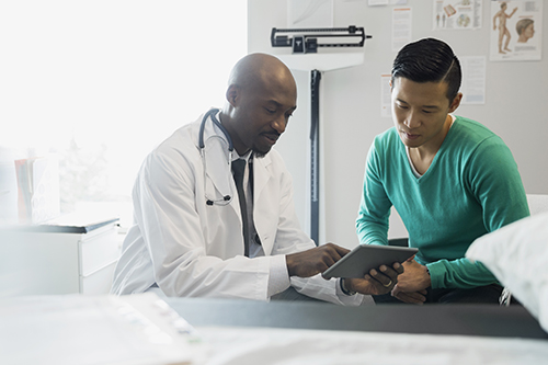 Doctor and patient looking at digital tablet