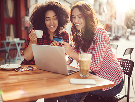 Girls drinking coffee and shopping online