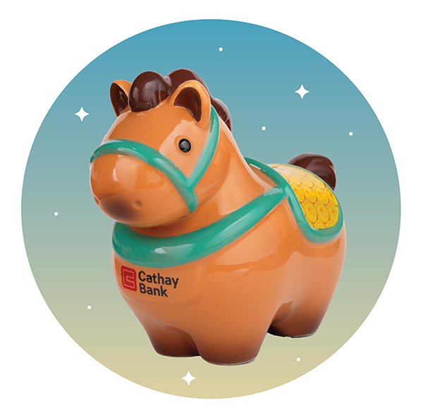 A horse-shaped money bank with a light brown body, teal harness, and yellow saddle, featuring the Cathay Bank logo on its side, displayed against a light blue circular background.