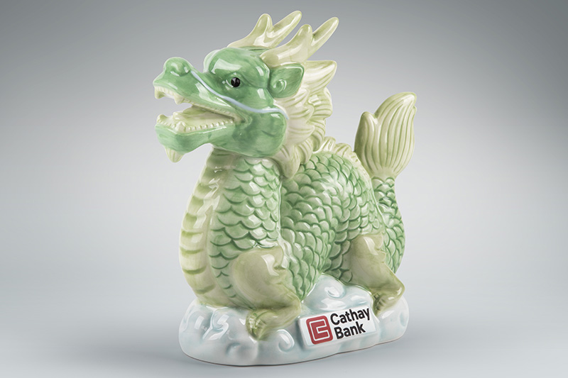 Cathay Bank’s fortune dragon ceramic money bank in light green and pastel green colors.
