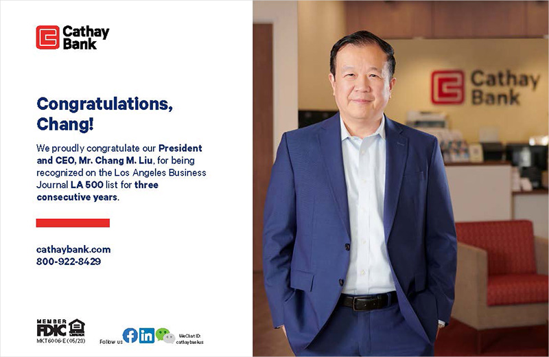 Chang M. Liu stands inside a Cathay Bank Branch wearing a dark navy suit and smiles at the camera.