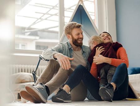 Happy family playing with their son at home. 