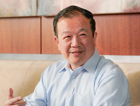 Cathay Bank’s President and CEO, Chang M. Liu, sits down to chat with others during a business meeting.