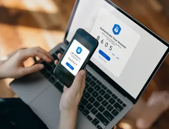 A client logs onto their online banking platform through a laptop using two factor authentication through their mobile device.