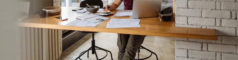 Young man at home, paying bills online