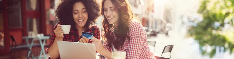 Girls drinking coffee and shopping online.