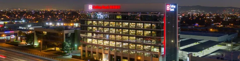 Cathay Bank’s corporate center building stands tall against the night sky in San Gabriel Valley.