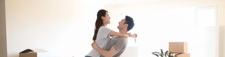 Happy young couple moving to a new house