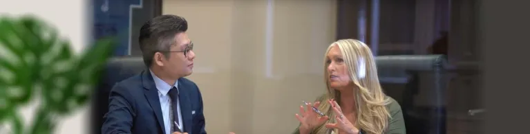 DKKD Staffing CEO Diane Krehbiel-Delson speaking to a Cathay Bank banker in a business meeting