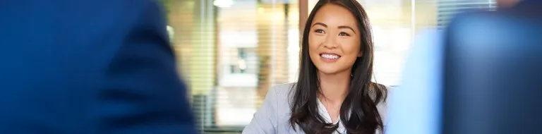 Woman in an office smiling.