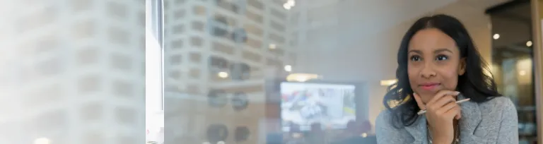 A young architect looking away at desk