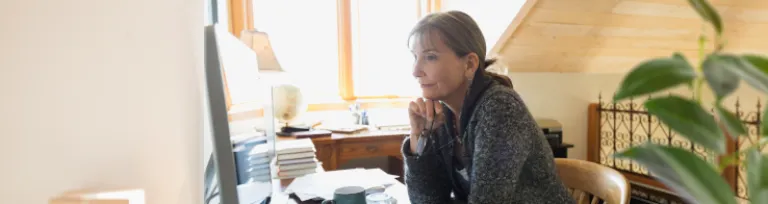 Woman using computer in home office