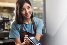 Cafe cashier using card machine.