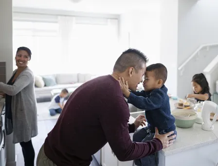 Affectionate family making breakfast in kitchen