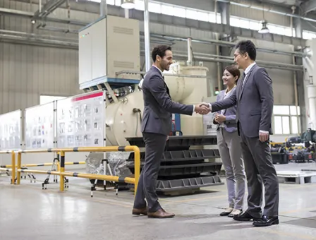 Business people shaking hands in the factory