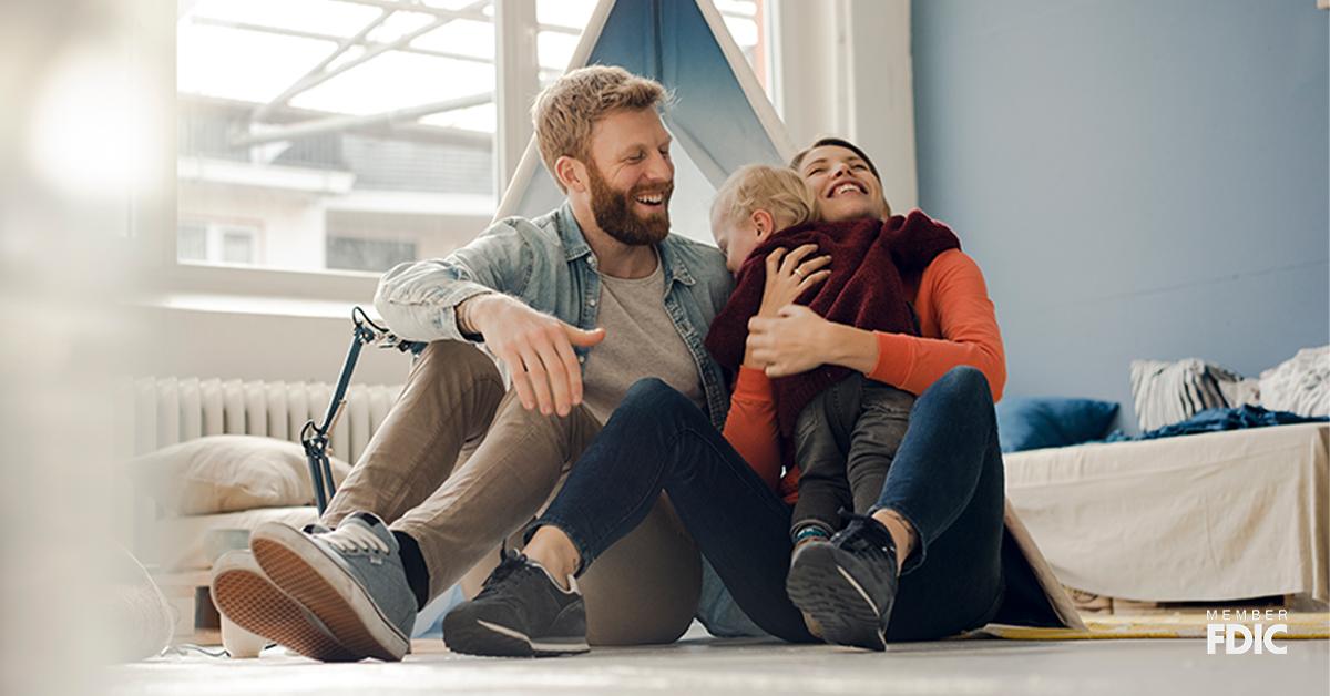 Happy family playing with their son at home. Member FDIC logo on the lower right corner of image.