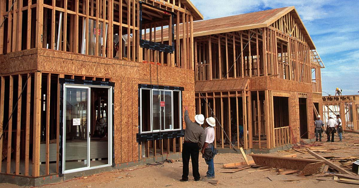 Contractors building house frame