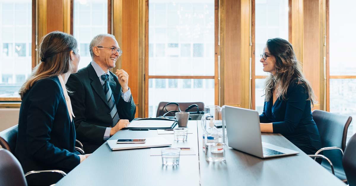 Lawyers in a professional setting discussing the management of client trust funds.