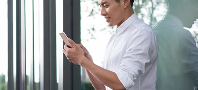 Young businessman using smart phone.