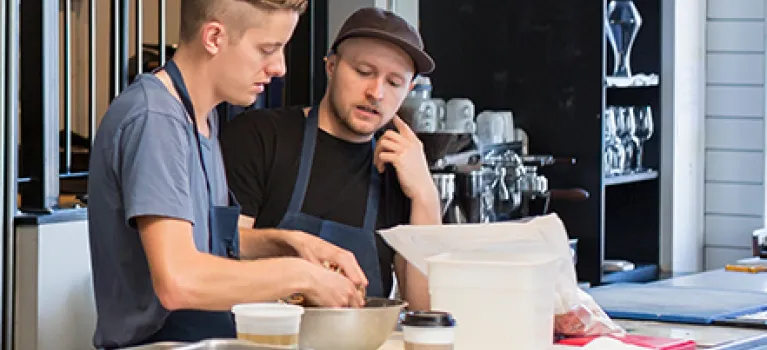 Chefs talking in restaurant kitchen