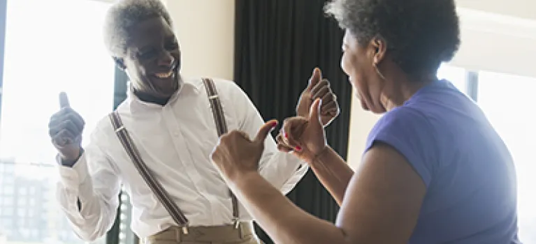 Playful, active senior couple dancing