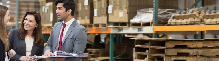 Cathay Bank banker discusses lending solutions with two businesswomen.