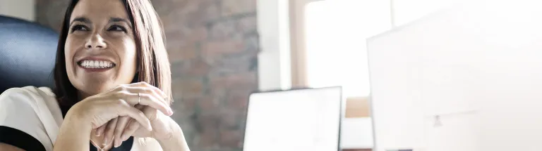 Smiling businesswoman at office desk