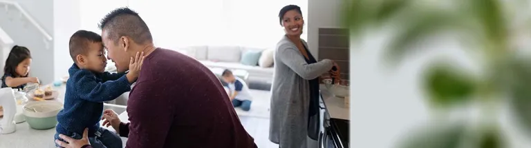 Affectionate family making breakfast in kitchen