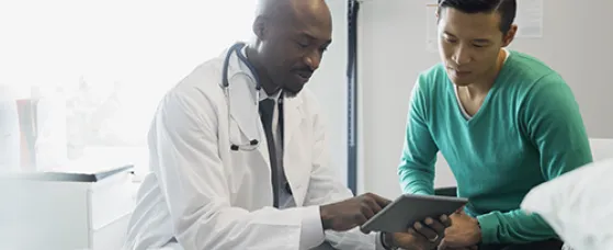 Doctor and patient looking at digital tablet