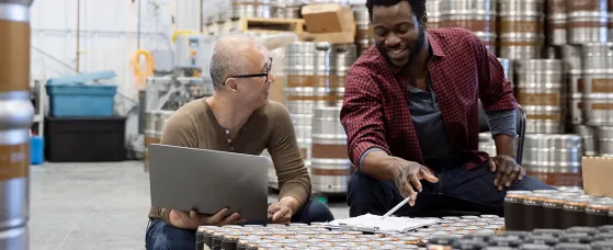 Two staff working in warehouse.