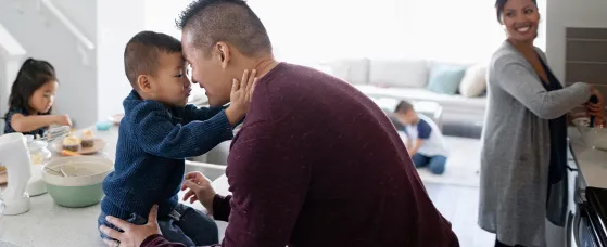 Affectionate family making breakfast in kitchen
