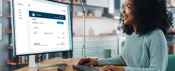 A businesswoman using her Autobooks service to email an invoice to her client.