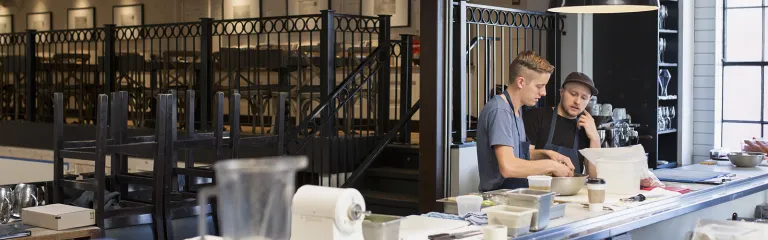 Chefs talking in restaurant kitchen