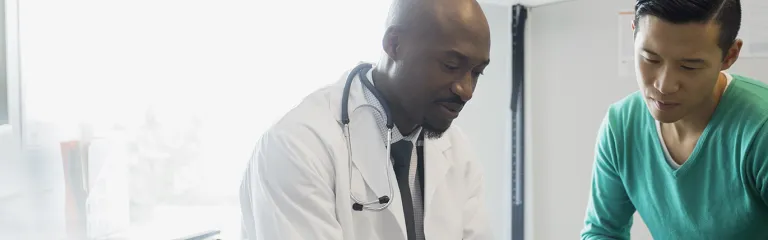 Doctor and patient looking at digital tablet
