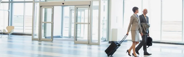 Business people with suitcases in modern lobby