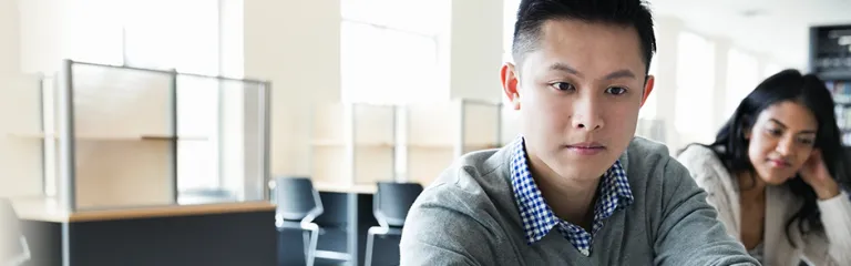 Student using laptop in college library