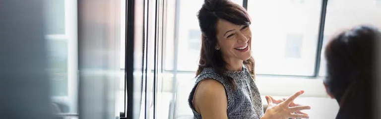 Smiling businesswomen talking in office