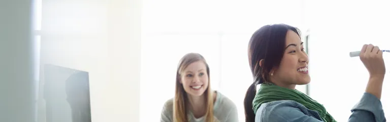 Female students working in classroom at college campus